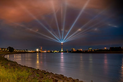 Illuminated city at waterfront
