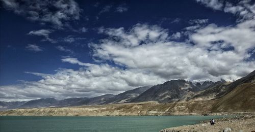 Scenic view of sea and mountains against sky