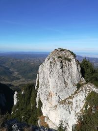 Scenic view of mountain against blue sky