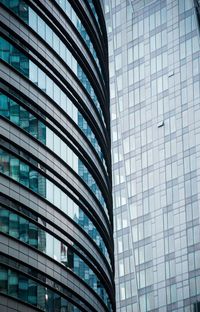 Low angle view of modern glass building in city
