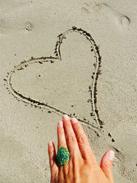 High angle view of heart shape on sand