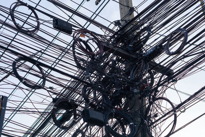 Low angle view of electricity pylon against sky