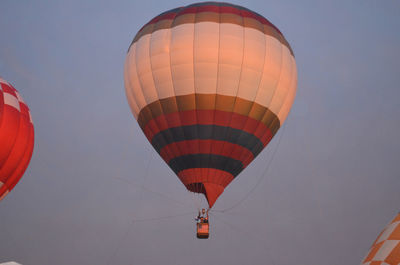 Low angle view of hot air balloons flying in sky