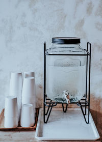 Close-up of objects on table against wall in winter