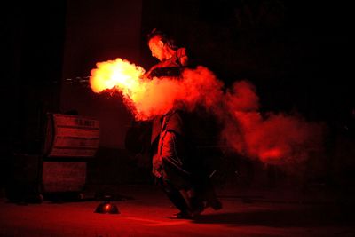 Reflection of man in fire at night