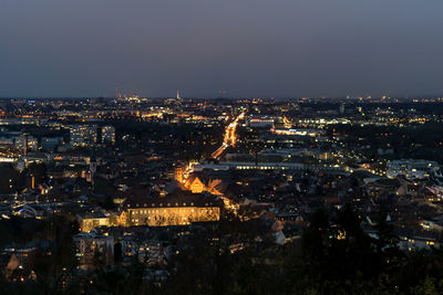 High angle view of illuminated city against sky at night