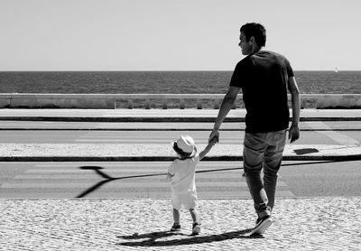 Full length of woman standing by railing