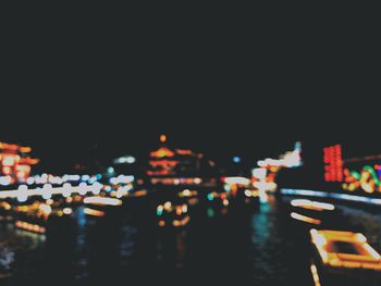 Illuminated city buildings against clear sky at night