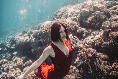 Woman on rock in sea