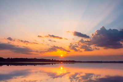 Sunset reflection lagoon. beautiful sunset behind the clouds and blue sky above the over lagoon