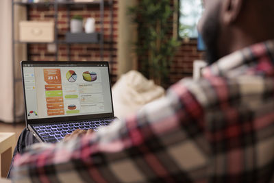 Midsection of woman using laptop