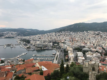 High angle view of city by river against sky