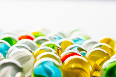 Close-up of multi colored candies against white background