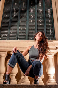 Portrait of young woman sitting on staircase