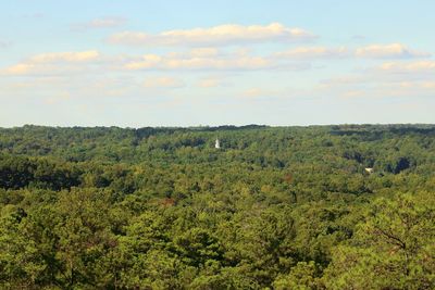 Scenic view of grassy landscape against cloudy sky