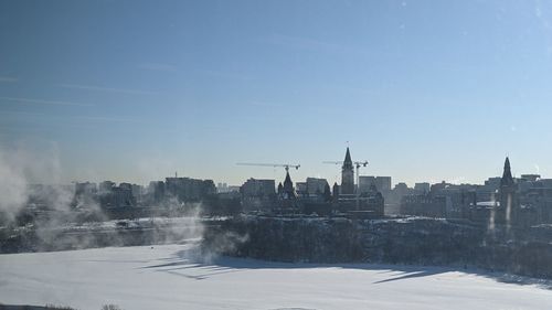 View of city against clear sky during winter