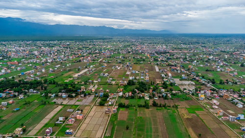 High angle view of buildings on field against sky