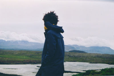 Man standing on mountain against sky