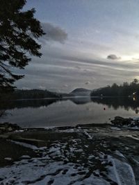 Scenic view of frozen lake against sky during sunset