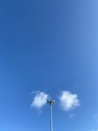 Low angle view of street light against blue sky