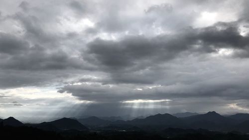 Scenic view of mountains against cloudy sky