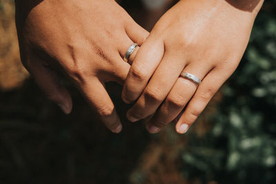 Midsection of couple holding hands