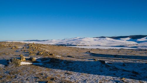 Scenic view of mountains against clear blue sky
