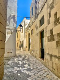 Narrow alley amidst buildings in city