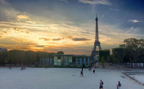 People walking in city at sunset