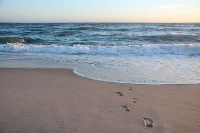 Scenic view of beach against sky during sunset