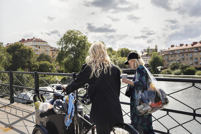 Woman crossing bridge together