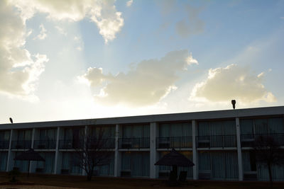 Low angle view of building against cloudy sky