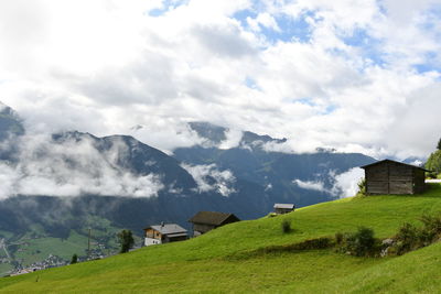 Scenic view of landscape and houses against sky