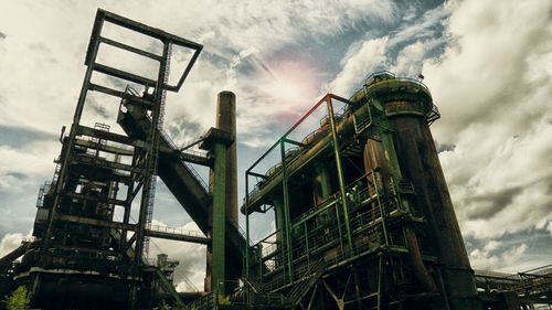 Low angle view of factory against sky