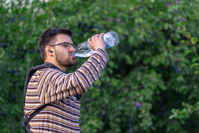 Side view of boy drinking water