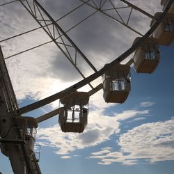 Low angle view of cranes against sky