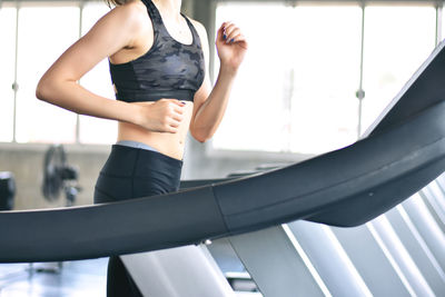 Midsection of woman standing at home