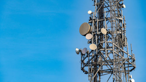 Large telecommunications tower with various communications broadcast equipment. mid shot