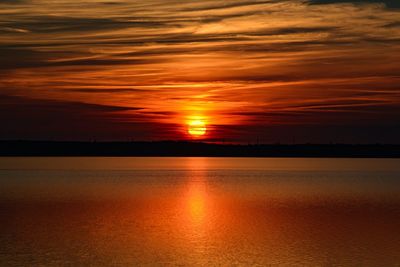 Scenic view of sea against romantic sky at sunset