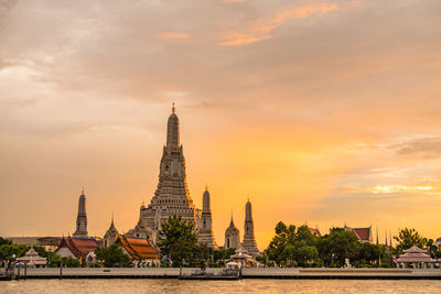 Tower of building against sky during sunset