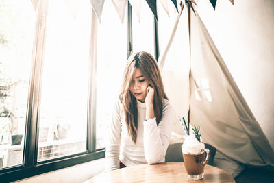 Beautiful woman sitting at table