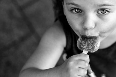 Close-up portrait of girl eating ice cream