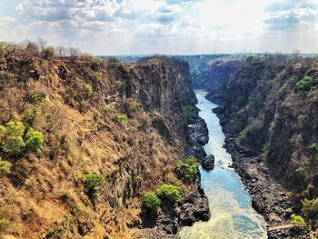 Scenic view of waterfall against sky