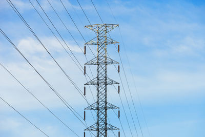 Low angle view of electricity pylon against sky