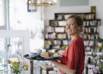 Portrait of smiling woman holding food