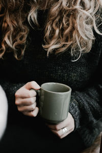 Close-up of woman holding coffee cup