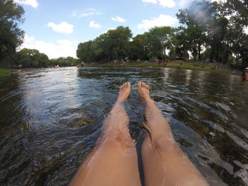 Low section of woman relaxing in lake