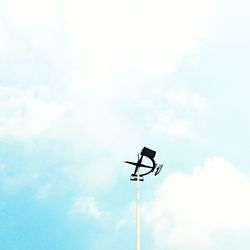 Low angle view of weather vane against sky