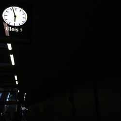 Low angle view of clock at night