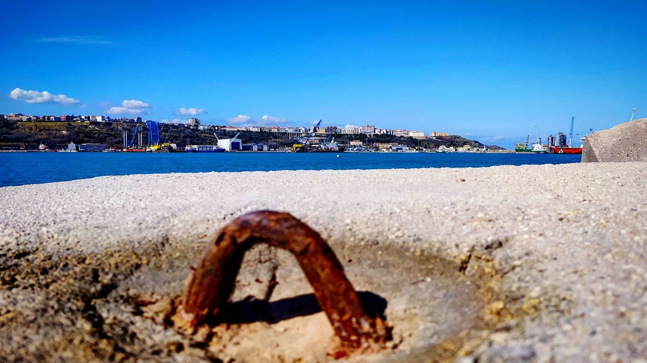 sky, water, sea, nature, land, beach, day, architecture, building exterior, no people, built structure, clear sky, blue, city, rusty, outdoors, metal, harbor, nautical vessel